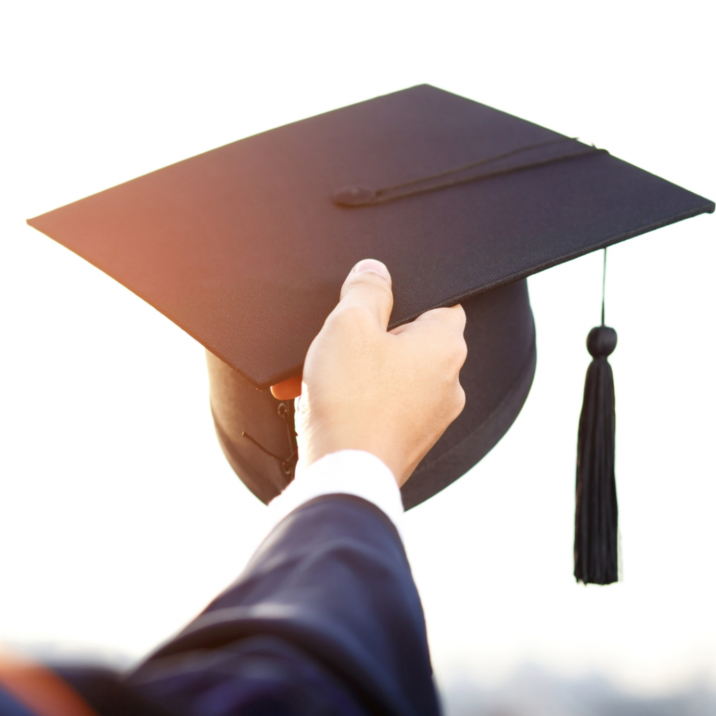 graduate holding graduation hat